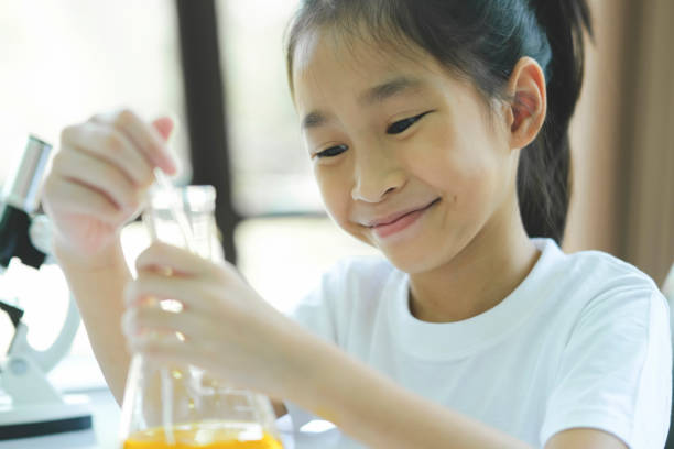 istock Little child with learning science class in school laboratory 1496272843