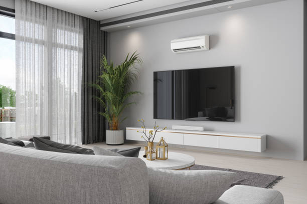 modernes wohnzimmer mit klimaanlage, fernseher, topfpflanze und sofa - air conditioner window heat hot day stock-fotos und bilder