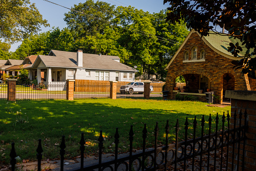Residential district with single family houses and lawns along North Parkway in Crosstown District. Car parked near the house in Memphis, Tennessee