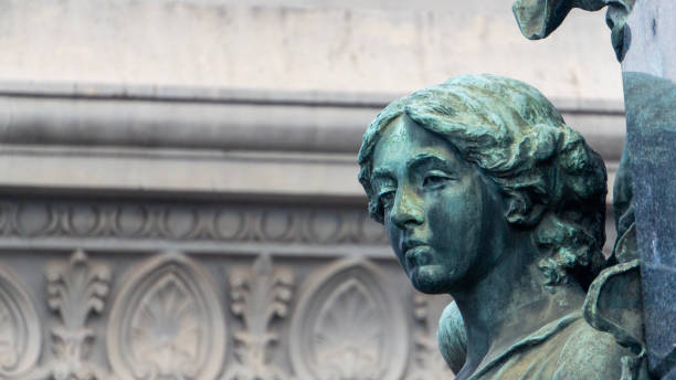 Statue in a cemetery of Paris at sunset