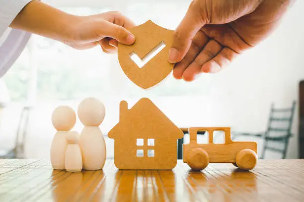 Photo of Businessman holding shield protect icon with his child, Security protection and health insurance. The concept of family home, protection, health care day, car insurance and home school education.