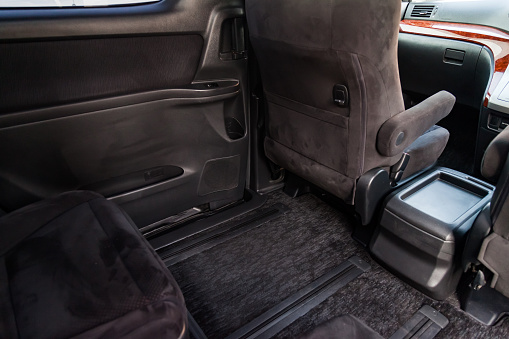 Clean car floor mats of black carpet with gas pedals and brakes in the workshop for the detailing vehicle after dry cleaning