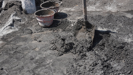 Mound the cement and sand mixture with shovels and buckets during construction