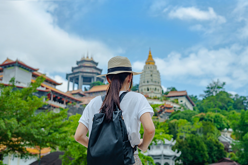 rear view of female tourist visiting Kek Lok Si Temple in Penang