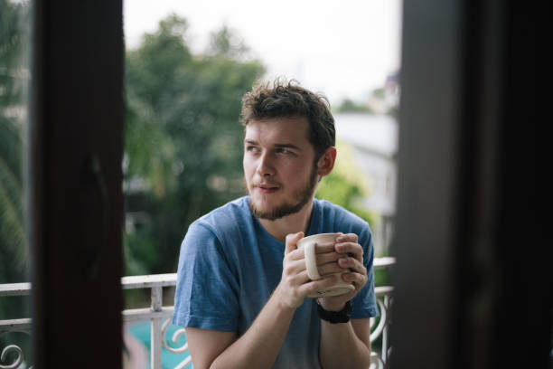 istock Bearded Man Having Cup Of Coffee On Balcony 1496286367