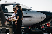 A flight instructor and her student going through the pre-flight check