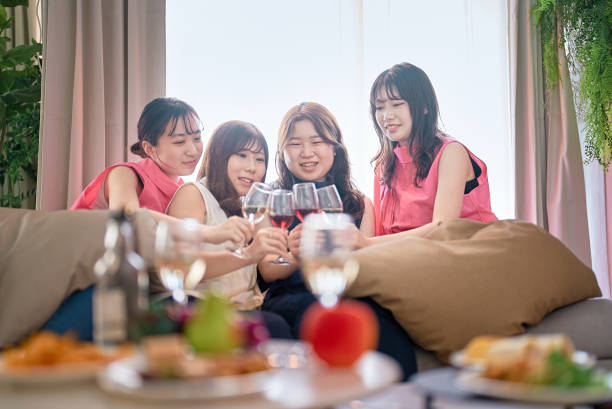 istock Four women toasting with wine 1496290013