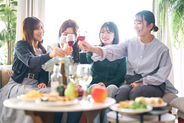 istock Four women toasting with wine 1496290138