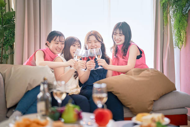 istock Four women toasting with wine 1496290182