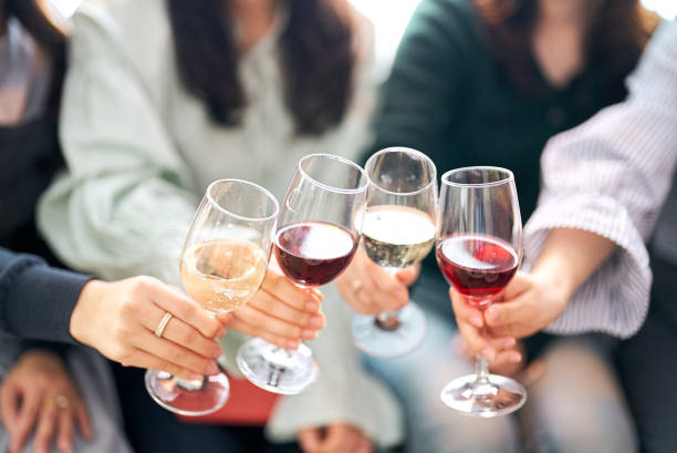 istock Four women toasting with wine 1496290239