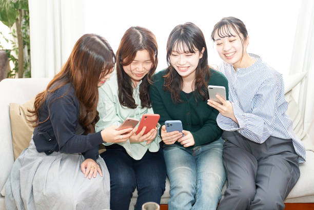 istock Four women talking while looking at a smartphone 1496290810