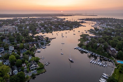 Aerial view of the Chesapeake Bay in Annapolis, Maryland at sunrise, with the sun illuminating the calm waters for a peaceful and tranquil scene