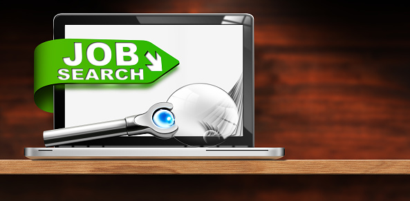 Job Search Concept. 3D illustration of a modern laptop computer with text Job Search and a magnifying glass on a wooden desk with copy space.
