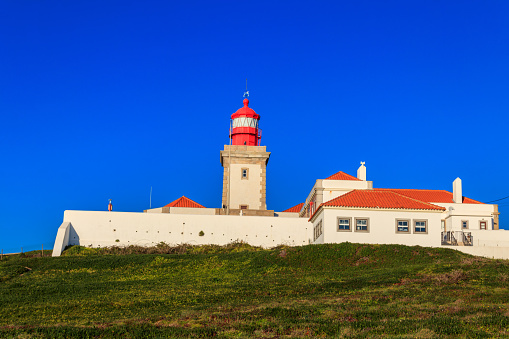 Lighthouse on the cliff at Cabo da Roca. Cabo da Roca or Cape Roca is westernmost cape of mainland Portugal, continental Europe and the Eurasian land mass