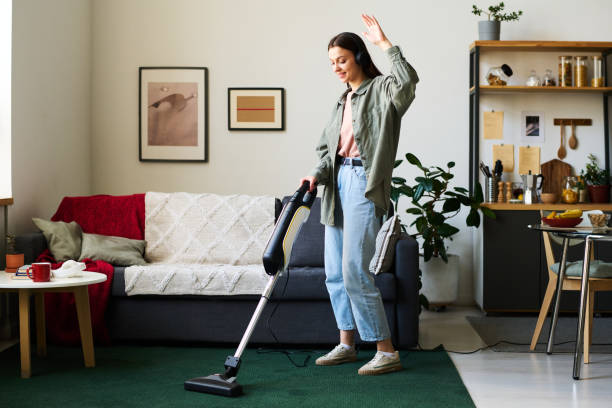 istock Woman listening to music during housework 1496295242