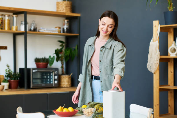 istock Woman listening to smart speaker in the kitchen 1496295992