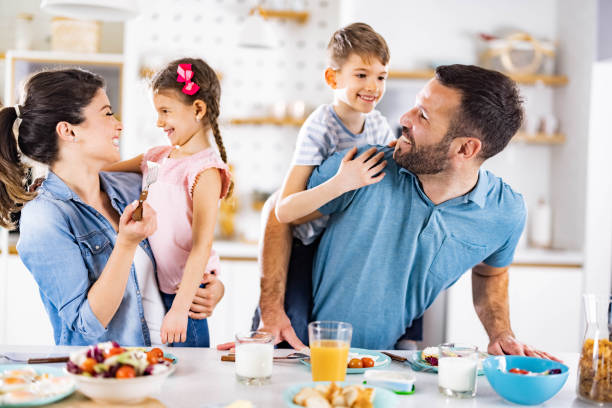 istock Happy family talking during breakfast in dining room. 1496297067