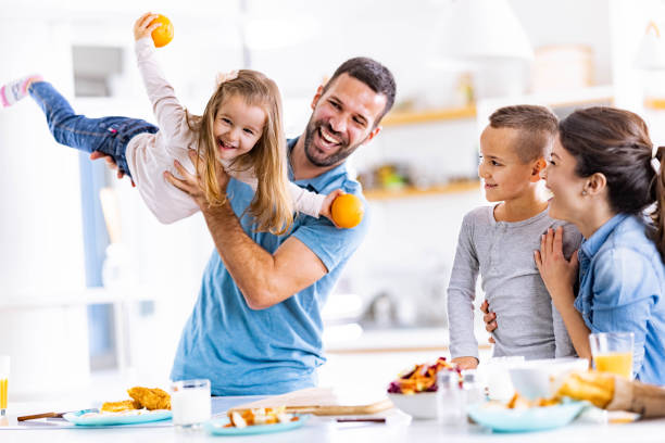 Cheerful family having fun in dining room.