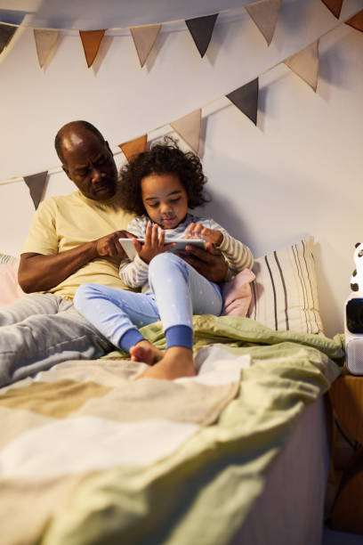 istock Little boy watching video on tablet pc with dad 1496297760