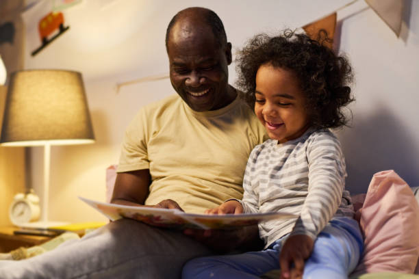 istock Dad reading tale to his little son 1496297825