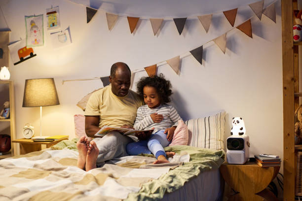 istock Father reading book to his son before sleep 1496297837