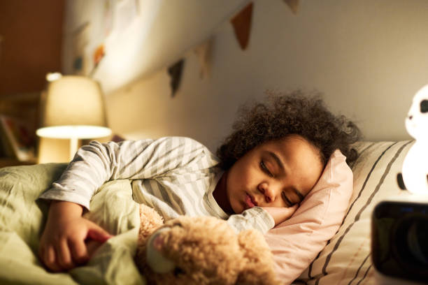 istock Little boy sleeping in bed with toy 1496298827