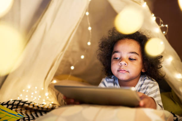 istock Little boy watching cartoon on tablet pc 1496299224
