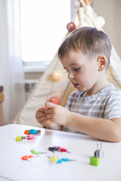 istock The child works with with colored locks. Picks up keys. Develops fine motor skills. 1496299491