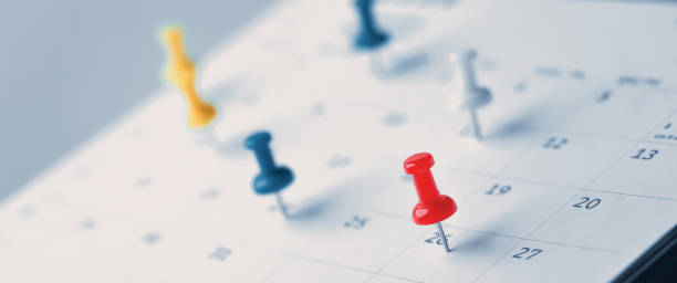 istock Embroidered red pins on a calendar event Planner calendar,clock to set timetable organize schedule,planning for business meeting or travel planning concept. 1496299748