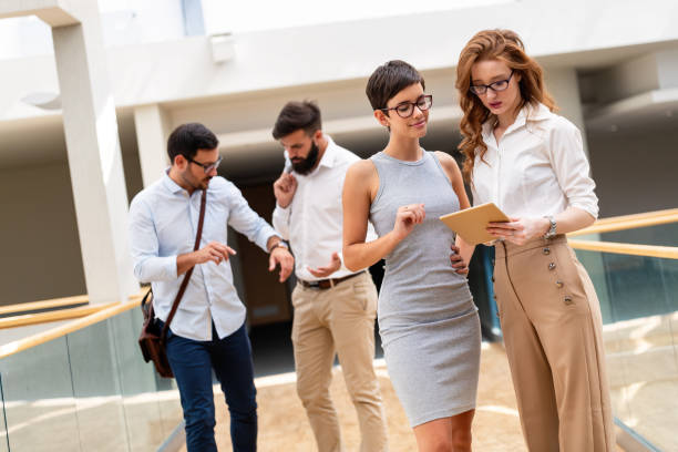 istock Business people having fun, teamwork and chatting at workplace office together. 1496300358