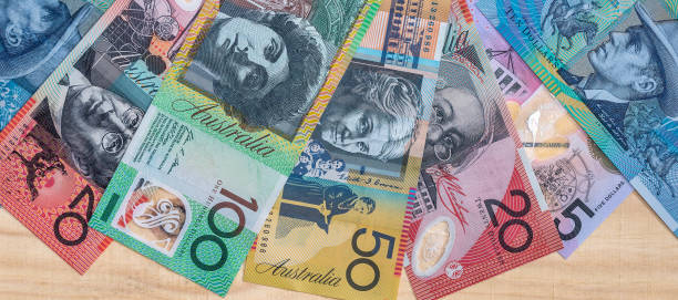 Australian dollar banknotes in fan on wooden background AUD or Australian note currency as finance background. Money and finance. australian dollar stock pictures, royalty-free photos & images