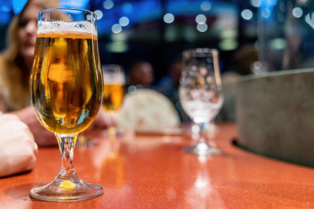 istock Glass of light beer in a dark pub 1496305216