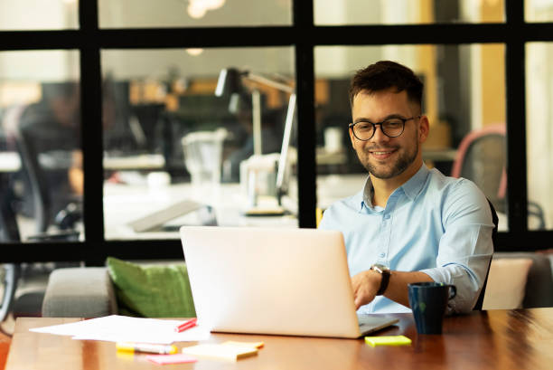 istock Portrait of handsome man working on laptop. 1496305756