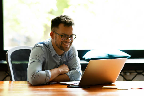 istock Young smiling man working on the project in office. 1496305854