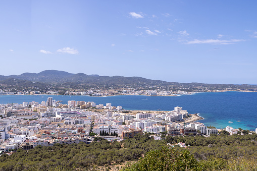 Photo of the town of Sant Antoni de Portmany on the west coast of Ibiza, one of Spains Balearic Islands, showing the ocean front by the hotels in the town centre in the summer time.