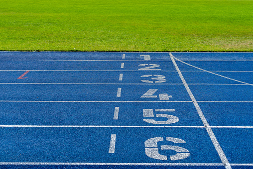 High angle view of numbers of finish lane of blue running track, Berlin Charlottenburg