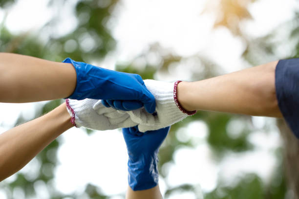 istock Group of hands with gloves present Collaborate and teamwork, Volunteer charity work.sustainable development goal.Group of diverse people multiethnic unity togetherness in the Volunteer community. 1496309763