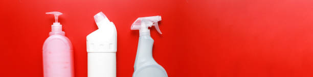 istock Banner Flat lay cleaning products on a red background. Cleaning bottle mockup 1496310004