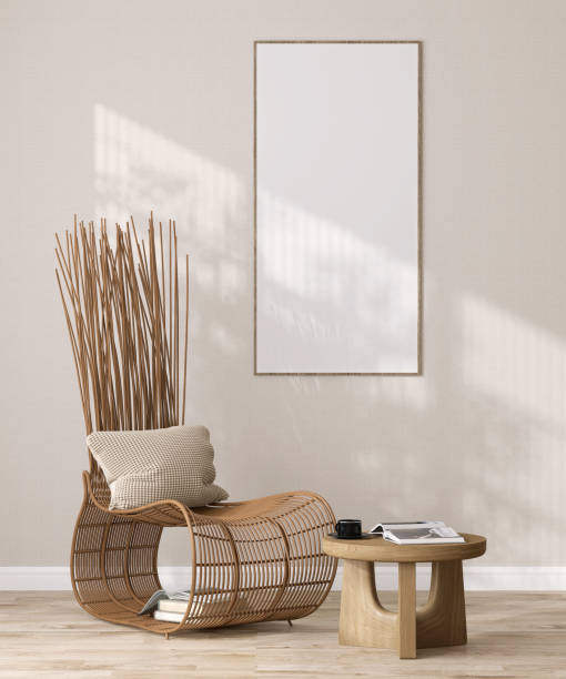 istock Blank long vertical photo poster frame on beige fabric texture wallpaper wall in parquet floor Japanese living room, wooden yoda rattan chair, coffee table, book on parquet floor in sunlight from window 1496311902