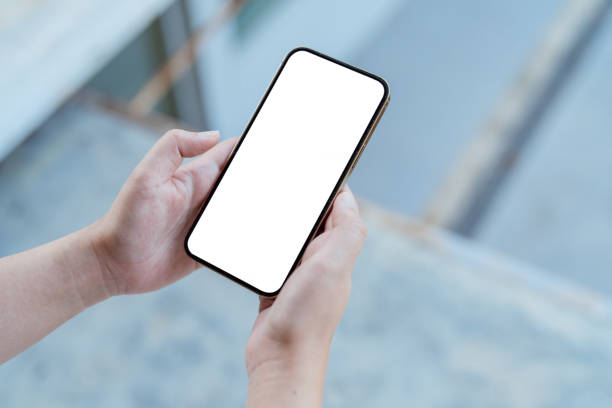 istock Women's hands holding cell telephone blank copy space screen. smartphone with blank white screen isolated. smart phone with technology concept. 1496312372