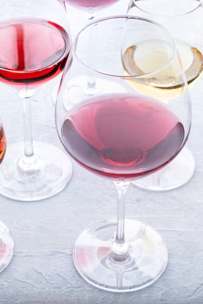 istock Wine glasses at a tasting. Rose, red, and white wine, drinks on a table 1496312673