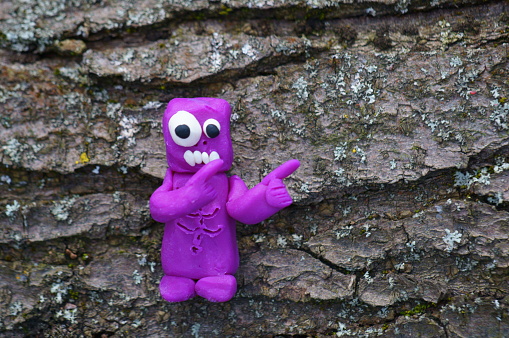 A figure of a funny zombie pointing with his index finger.