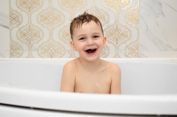 Asian Grandchild and Grandfather taking a bath at home.