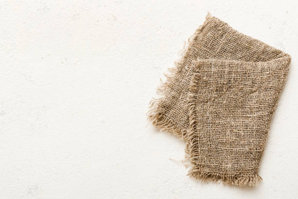 istock Old burlap fabric napkin, sackcloth on table background. top view with copy space 1496314576