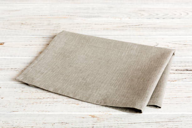 istock top view with gray kitchen napkin isolated on table background. Folded cloth for mockup with copy space, Flat lay. Minimal style 1496314585
