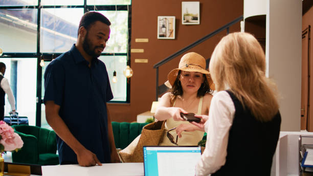 istock Hotel guests showing passports 1496315129