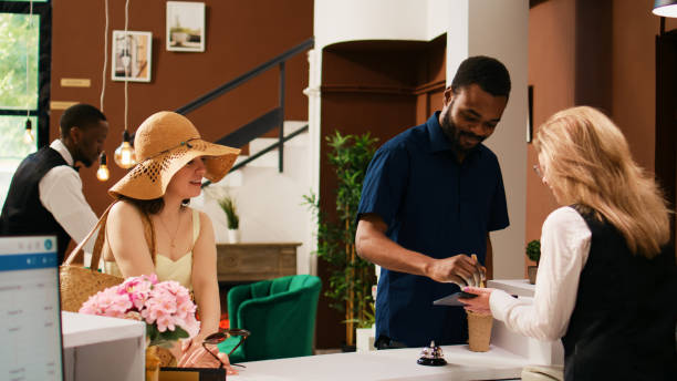 istock Hotel guests checking in at reception 1496315378