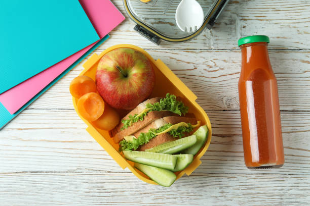 istock Study concept with lunch box on white wooden table 1496315622