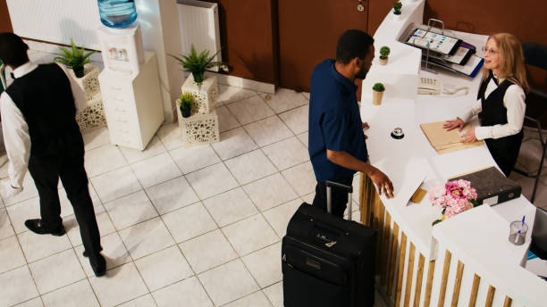istock Hotel guest entering at reception lobby 1496315630