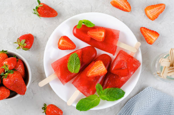 istock Refreshing Strawberry Popsicles, Ice Lolly with Fresh Strawberry and Mint on Bright Background 1496316479